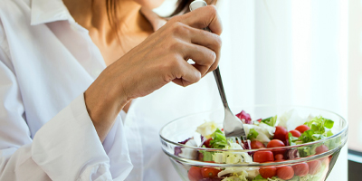 Woman eating a salad.