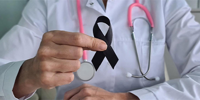 Doctor holding a black Skin Cancer ribbon.