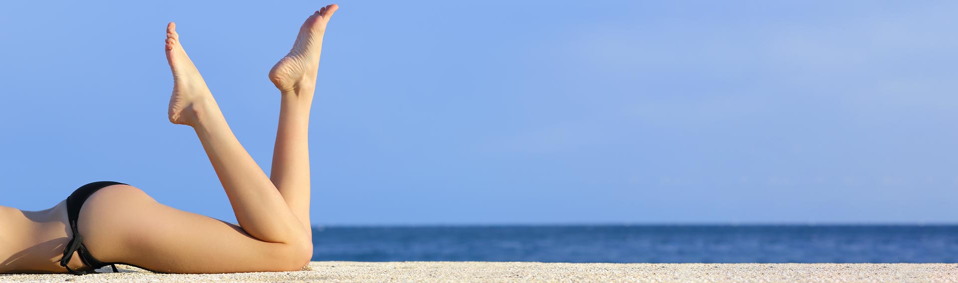 Woman Legs on Beach